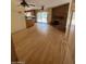Open-concept area with hardwood floors, a brick fireplace, and a bright kitchen at 3144 N 84Th Pl, Scottsdale, AZ 85251