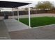 Backyard patio with a covered area, an artificial lawn, and a fenced perimeter at 329 N 83Rd Pl, Mesa, AZ 85207