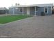 Backyard area featuring an artificial lawn, gravel area and grey-colored home at 329 N 83Rd Pl, Mesa, AZ 85207