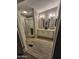 Well-lit bathroom featuring a glass-enclosed shower and double sink vanity with modern fixtures at 329 N 83Rd Pl, Mesa, AZ 85207