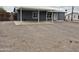 Exterior shot with a grey-colored single-story home with a covered carport and low maintenance gravel front yard at 329 N 83Rd Pl, Mesa, AZ 85207