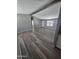 Open living room featuring modern flooring, neutral paint, and a decorative beam at 329 N 83Rd Pl, Mesa, AZ 85207