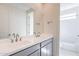 Bright bathroom featuring a double sink vanity with gray cabinets and a shower-tub combo at 35234 N Barley St, San Tan Valley, AZ 85144