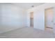 Neutral bedroom with plush carpet, walk-in closet, and a door to the bathroom at 35234 N Barley St, San Tan Valley, AZ 85144