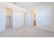 A clean bedroom with neutral carpet and access to the closet and bathroom at 35234 N Barley St, San Tan Valley, AZ 85144