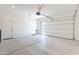 Spacious three car garage featuring large doors with window panels, high ceilings and white walls at 35234 N Barley St, San Tan Valley, AZ 85144