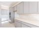 Kitchen features stainless appliances, gray cabinetry, and quartz countertops at 35234 N Barley St, San Tan Valley, AZ 85144