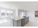 Kitchen island with stainless steel dishwasher and ample seating at 35234 N Barley St, San Tan Valley, AZ 85144