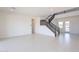 Bright, open living area with sleek tile flooring and a modern staircase at 35234 N Barley St, San Tan Valley, AZ 85144