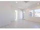 Open-plan living room featuring light tile flooring, recessed lighting, and modern doors at 35234 N Barley St, San Tan Valley, AZ 85144