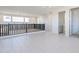 Open loft area featuring white walls, tile flooring, black railing and natural light at 35234 N Barley St, San Tan Valley, AZ 85144
