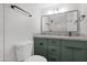 This bathroom showcases a toilet, and a modern vanity with granite countertops and black hardware at 3607 N 79Th Ave, Phoenix, AZ 85033