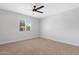 Bright bedroom with neutral carpet, white walls, and a ceiling fan, offering a cozy feel at 3607 N 79Th Ave, Phoenix, AZ 85033