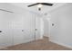 This bedroom features neutral carpet, a modern ceiling fan and closet with white doors at 3607 N 79Th Ave, Phoenix, AZ 85033