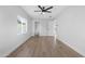 Minimalist bedroom with light wood flooring, white walls, and ample natural light at 3607 N 79Th Ave, Phoenix, AZ 85033