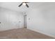 This bedroom features neutral carpet, a modern ceiling fan and closet with white doors at 3607 N 79Th Ave, Phoenix, AZ 85033