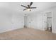 Bedroom with neutral carpet, white walls, ceiling fan, and sliding closet doors at 3607 N 79Th Ave, Phoenix, AZ 85033