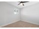 This bedroom features neutral carpet, a modern ceiling fan and a window with blinds at 3607 N 79Th Ave, Phoenix, AZ 85033