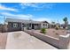 Single story home featuring a concrete driveway, desert landscape and unique concrete fence at 3607 N 79Th Ave, Phoenix, AZ 85033