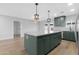 Open kitchen featuring a large center island with granite countertops and green cabinetry at 3607 N 79Th Ave, Phoenix, AZ 85033