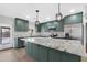 Updated kitchen featuring stainless steel appliances, a large granite island and pendant lighting at 3607 N 79Th Ave, Phoenix, AZ 85033