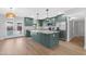 Gourmet kitchen featuring a large center island, stainless steel appliances, and backyard views at 3607 N 79Th Ave, Phoenix, AZ 85033