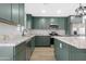 Spacious kitchen boasts granite countertops, green cabinets and stainless steel appliances at 3607 N 79Th Ave, Phoenix, AZ 85033