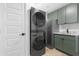 A laundry room featuring a stackable washer and dryer and a sink with granite countertop at 3607 N 79Th Ave, Phoenix, AZ 85033