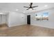 View of the living room featuring vinyl plank flooring, fresh paint and a modern ceiling fan at 3607 N 79Th Ave, Phoenix, AZ 85033
