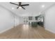 Spacious living room with updated lighting, ceiling fan and an open concept to the kitchen at 3607 N 79Th Ave, Phoenix, AZ 85033
