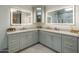 Bathroom with double sinks, custom vanity, and well lit mirrors in neutral colors at 3626 N Mohave Way, Scottsdale, AZ 85251