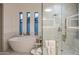 Luxurious bathroom with a soaking tub, marble shower, and elegant fixtures, offering a spa-like experience at 3626 N Mohave Way, Scottsdale, AZ 85251