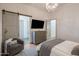 Comfortable bedroom with a barn door leading to the en-suite bathroom and modern furnishings at 3626 N Mohave Way, Scottsdale, AZ 85251