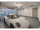 Spacious garage with a modern garage door and epoxy floors, showcasing a sleek white sports car at 3626 N Mohave Way, Scottsdale, AZ 85251