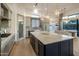 Bright kitchen features a large island, stainless appliances, and custom cabinetry at 3626 N Mohave Way, Scottsdale, AZ 85251