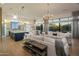 Open concept living space with hardwood floors, large windows, and a seamless flow to kitchen and dining at 3626 N Mohave Way, Scottsdale, AZ 85251