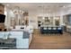 Spacious living room with fireplace, white sofa and open to kitchen area at 3626 N Mohave Way, Scottsdale, AZ 85251