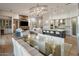 Open-concept living area with modern decor, brick fireplace, and glass dining table at 3626 N Mohave Way, Scottsdale, AZ 85251