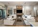 Spacious living room featuring a fireplace, built-in bar area, and neutral decor at 3626 N Mohave Way, Scottsdale, AZ 85251