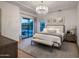 Well-lit main bedroom with chandelier, bench, and private access to the outdoor area at 3626 N Mohave Way, Scottsdale, AZ 85251