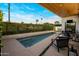 Backyard pool area featuring lounge furniture and green hedge and palm tree accents at 3626 N Mohave Way, Scottsdale, AZ 85251