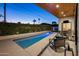 Backyard pool surrounded by greenery, complemented by an outdoor seating area for relaxation at 3626 N Mohave Way, Scottsdale, AZ 85251
