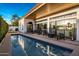 Relaxing backyard pool with modern patio furniture and sliding glass doors to the house at 3626 N Mohave Way, Scottsdale, AZ 85251