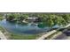 Aerial view of the Ranch House community clubhouse and lake with mature trees and a walking path at 4073 E Stable Ct, Gilbert, AZ 85297