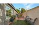 Cozy backyard featuring a brick-paved patio, artificial lawn, and charming outdoor seating area at 4073 E Stable Ct, Gilbert, AZ 85297