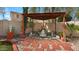 Tranquil backyard patio with decorative pergola, stone pavers, and a charming tiered water fountain at 4073 E Stable Ct, Gilbert, AZ 85297