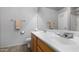 Bathroom featuring double sinks, a large mirror, and wood cabinets at 4073 E Stable Ct, Gilbert, AZ 85297