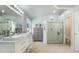 Stylish bathroom featuring double sinks, large mirror, walk-in shower and neutral flooring at 4073 E Stable Ct, Gilbert, AZ 85297