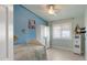 Light-filled bedroom featuring neutral floors, blue walls, and a ceiling fan at 4073 E Stable Ct, Gilbert, AZ 85297
