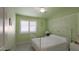 Cozy bedroom with light green walls, shuttered window, and ceiling fan at 4073 E Stable Ct, Gilbert, AZ 85297